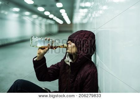 Homeless Alcoholism Woman Drinking Alcohol Sitting on The Floor
