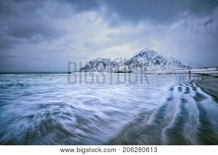 Waves on coast of Norwegian sea in fjord. Skagsanden beach, Flakstad, Lofoten islands, Norway. Long exposure motion blur