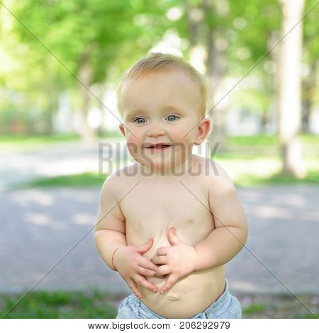 little boy walking outdoor. Child playing in summer park, image toned, soft focus