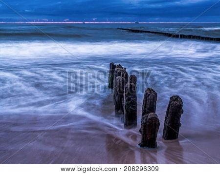 Old and weathered wooden wave breakers, Ustka, Baltic Sea, Poland 