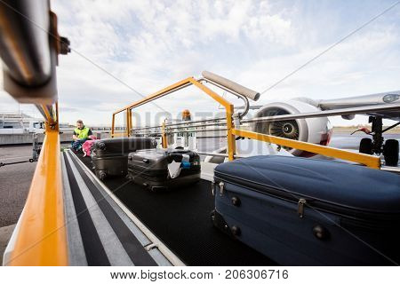 Baggage On Conveyor Belt Being Unloaded