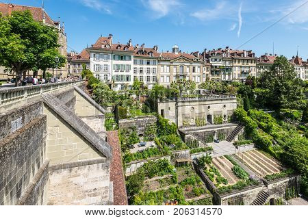 Bern Switzerland - May 26 2016: Upscale residential area with terraced gardens near the Bern Cathedral and Aare River. People on the Minster Terrace.