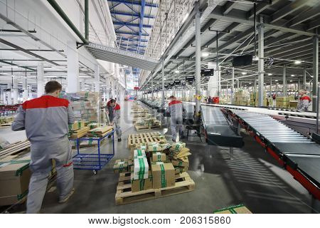 TVER, RUSSIA - MAY 17, 2017: People work in warehouse and sorting center of Ozon internet shop, it takes sixth place in list of most expensive russian internet companies 