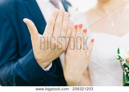 Hands Of Bride And Groom With Rings.