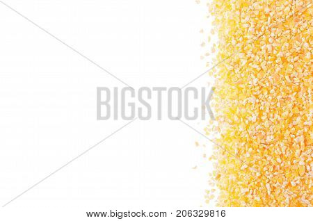 Corn grits groats as decorative border isolated on white background. Top view closeup.