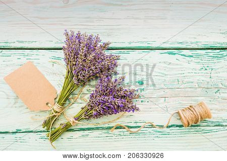 Lavender herbs on the wooden table with space for text.
