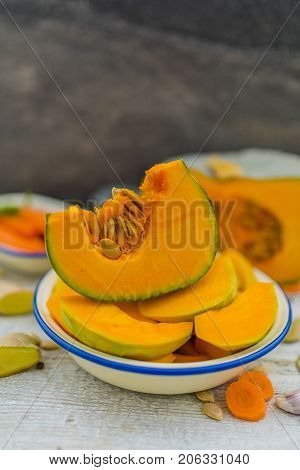 Portions pumpkin on the table in the kitchen ready to cook.