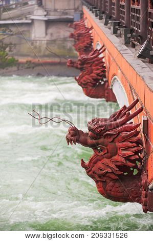 Red dragon heads on a bridge in Dujiangyan, China
