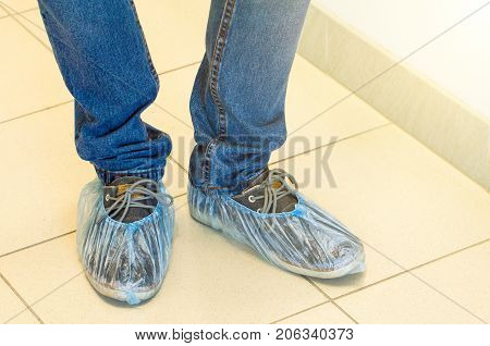Shoe covers on shoes on the floor