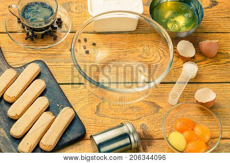 Photo savoyardi cookies on cutting board, cups, coffee, cream cheese, yolks and squirrels