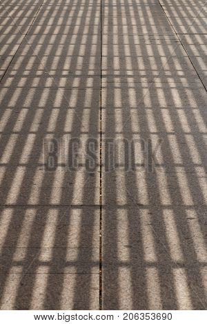 Shadow From A Pergola On A Road Tile