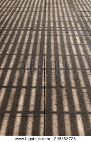 Shadow From A Pergola On A Road Tile
