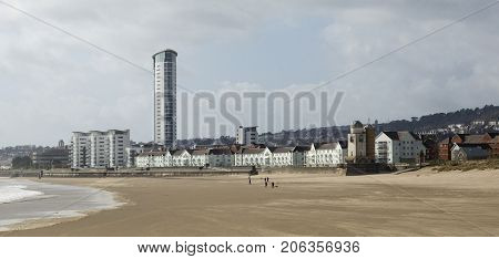 Swansea beach near the SA1 development in a panoramic format. The Meridian Tower dominates the area and new apartment buildings have sea views from the Maritime Quarter