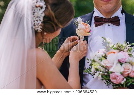 Wedding flowers bouquet and buttoniere in bride and groom hand