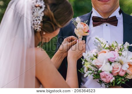 Wedding flowers bouquet and buttoniere in bride and groom hand