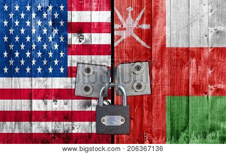 US and Oman flag on door with padlock