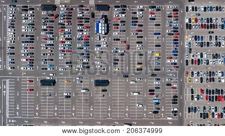 Aerial top view of parking lot with many cars from above, city transportation and urban concept