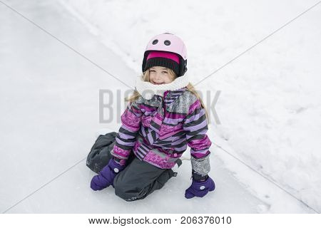 A little girl enjoying ice skating in winter season