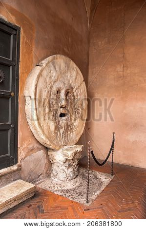 The Mouth of Truth (La Bocca della Verita) carved from Pavonazzo marble in the portico of the church of Santa Maria in Cosmedin in Rome Italy