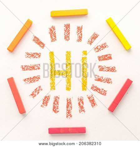 Top view of word HI inside a frame made of colorful pastel chalks, over white background