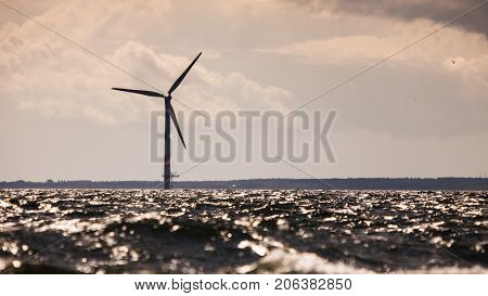 Vertical axis wind turbines generator farm for renewable sustainable and alternative energy production along coast baltic sea near Denmark. Eco power ecology.