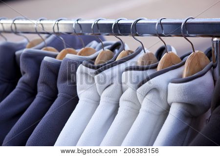 Fleece jackets hanging on coat hangers in a fashion store