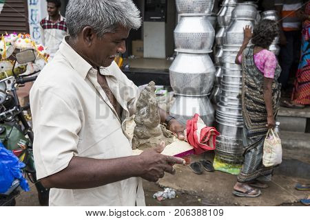 Close up of hand crafted Ganesha idol clay statues displayed in the market during Ganesh Festival.