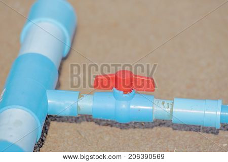 Pipes and valves of water Equipment for the delivery of agricultural waterFaucet with a PVC pipewater valve plumbing joint steel tap pipe with copy space add text