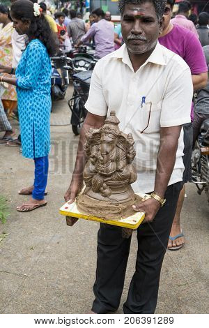Close up of hand crafted Ganesha idol clay statues displayed in the market during Ganesh Festival.