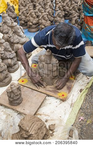 Close up of hand crafted Ganesha idol clay statues displayed in the market during Ganesh Festival.
