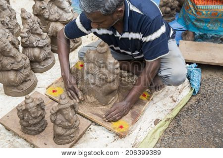 Close up of hand crafted Ganesha idol clay statues displayed in the market during Ganesh Festival.
