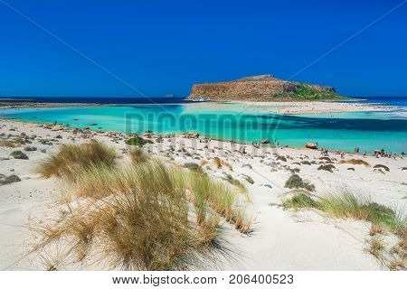 Amazing view of Balos Lagoon with magical turquoise waters, lagoons, tropical beaches of pure white sand and Gramvousa island on Crete, Greece