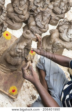 Close up of hand crafted Ganesha idol clay statues displayed in the market during Ganesh Festival.