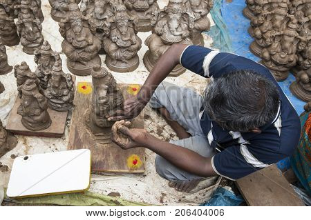 Close up of hand crafted Ganesha idol clay statues displayed in the market during Ganesh Festival.