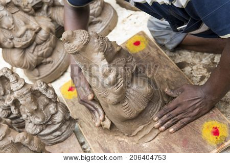 Close up of hand crafted Ganesha idol clay statues displayed in the market during Ganesh Festival.