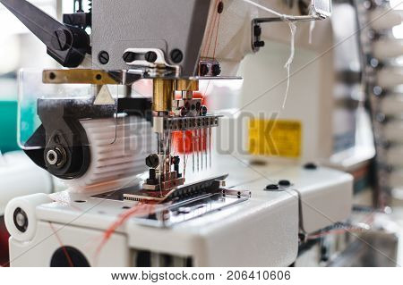 Closeup detail of the sewing machine. Sewing process in the phase of overstitching