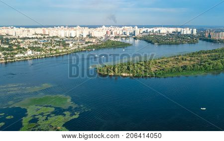 Aerial top view of Darnitsky bridge, Dnieper river and cityscape from above, city of Kiev, Ukraine
