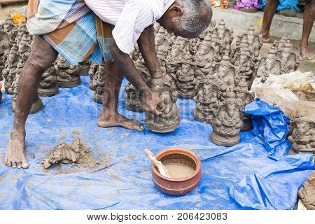 Close up of hand crafted Ganesha idol clay statues displayed in the market during Ganesh Festival.
