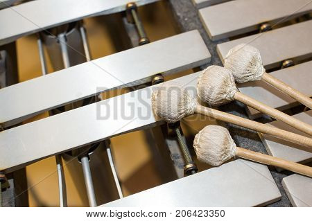 xylophone, music and chromatic instrument concept - closeup on wooden bars with four mallets, glockenspiel, marimba, balafon, semantron, pixiphone, education and orchestra concert use, selective focus