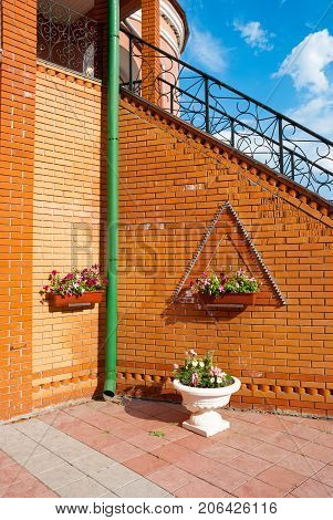 Flowers in a flower pot on the wall. The Gustynsky Monastery. Ukraine