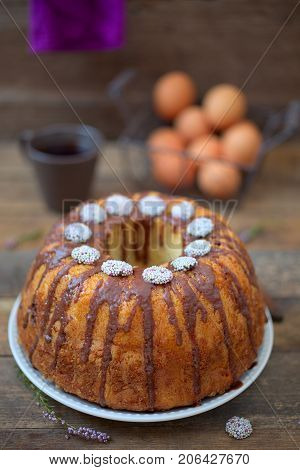 Bundt Cake with Chocolate Fudge Glaze and Chocolate dots circle candy nonpareils with colorful sprinkles on top 
