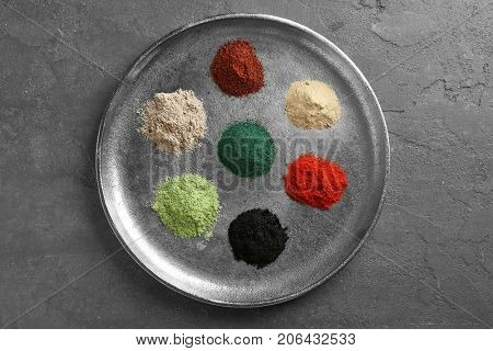 Different colorful superfood powders on metal tray