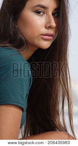 Serious Youthful Person with Long Brunette Hair