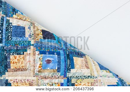 interior, decoration, handmade, design, sewing concept - there is one corner of multicolored blanket like puzzle made of little rags with folksy patterns and white space for lettering
