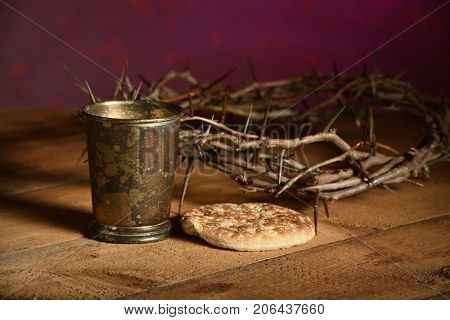 Communion elements with crown of thorns over vintage table
