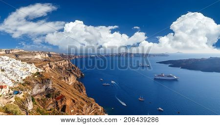 Panoramic bird eye aerial view of white building, blue sky and vivid sea in Santorini island