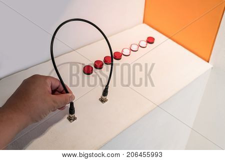 Hand Pluging In A Black Cable Into An Input Outlet.