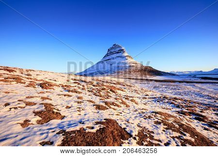 Kirkjufellsfoss Waterfall with Kirkjufell mountain at sunrise Iceland