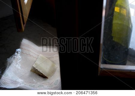 sardinian pecorino illumined from light of a window