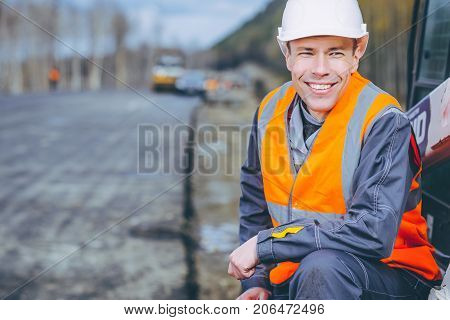 male worker road construction infrastructure repair pavement